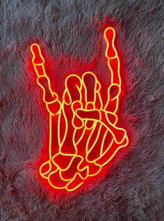 a neon sign that is on top of a furry surface in the shape of a hand