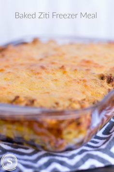 baked ziti freezer meal in a glass dish on a black and white towel