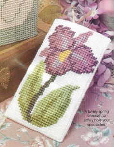 a cross stitch book with flowers on it