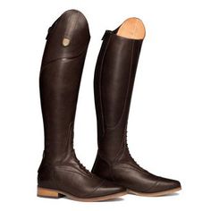 a pair of brown riding boots sitting on top of each other