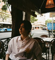 a man sitting at an outdoor cafe table