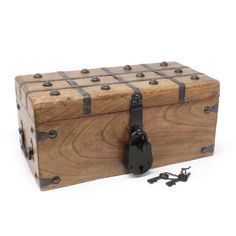 a wooden box with metal straps and latches on the front, sitting next to a pair of scissors