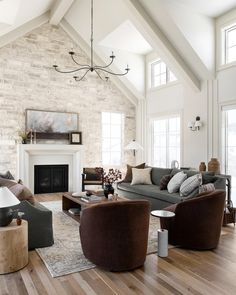 a living room filled with furniture and a fire place in the middle of a room