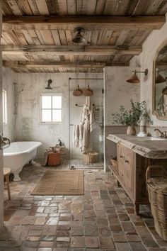 a rustic bathroom with stone flooring and exposed wood ceiling, along with an antique bathtub