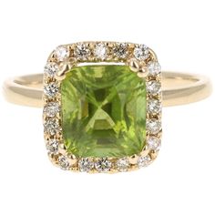 an engagement ring with a square cut green stone surrounded by small white and yellow diamonds