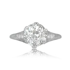 an old cut diamond ring with two side stones on the shoulders and sides, set in white gold