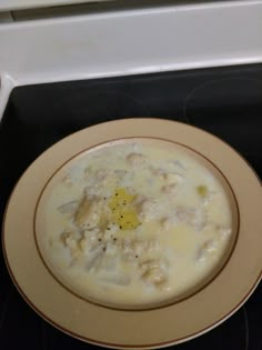 a bowl of soup sitting on top of a stove