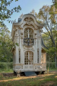 a white house sitting on top of a lush green forest filled with lots of trees