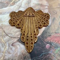 an ornate gold brooch with intricate details