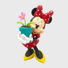 a mickey mouse figurine holding a flower pot