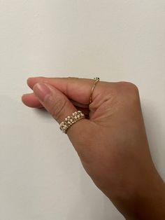 a person's hand holding onto a ring