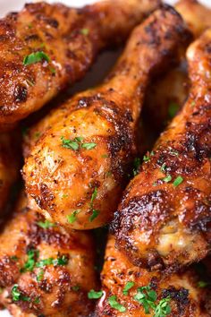 chicken wings with parsley on top in a white bowl