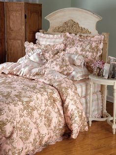 the bed is made with pink and gold comforters