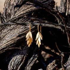 A panicle of delicate gold leaves, beautifully handcrafted in 18k gold with a satin finish. The leaves all move individually adding to the ethereal quality of these distinctive gold earrings from Sia Taylor.Metal: 18k Yellow GoldMeasurement: 17.5mm length Please allow 4-5 weeks for delivery All MADE TO ORDER items are final sale Golden Leaf, Golden Leaves, Gold Leaves, Leaf Earrings, Gold Leaf, Satin Finish, Final Sale, Gold Earrings, 18k Gold