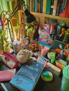 a desk with many books and toys on it