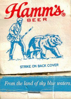 a sign on the side of a building that says hamms beer strike on back cover from the land of sky blue waters