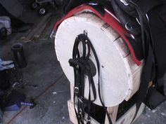 the back end of a horse's bridle and saddles are stacked on top of each other