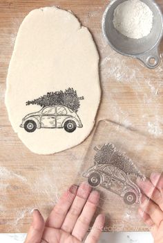 someone is making a cookie with a car and tree on it