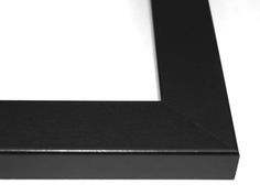 a black frame sitting on top of a white table