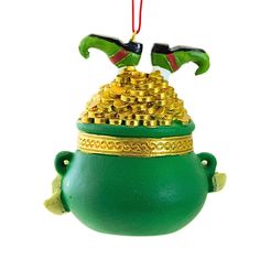 a green pot with gold coins hanging from it's side on a red string