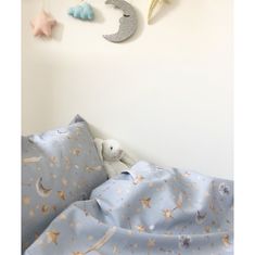 there are stars and moon decorations on the wall next to the baby's bed