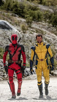 two men in deadpool costumes walking down a dirt road