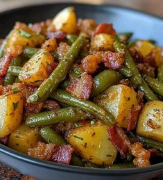 a bowl filled with potatoes and green beans