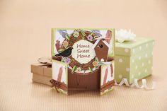 a small card with a horse on it next to a gift box and tissue dispenser