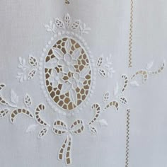 an embroidered white fabric with gold trim