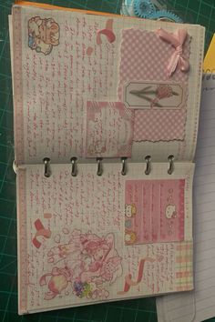 an open notebook with many different papers on it