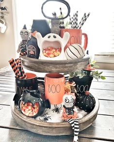 a three tiered tray filled with halloween decorations