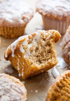 muffins with icing and sprinkles sitting on a table