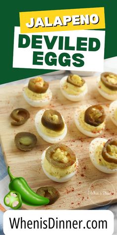 deviled eggs with jalapeno peppers on a cutting board