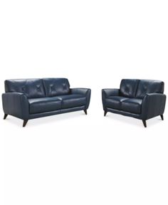 two blue leather sofas sitting next to each other on a white background with the same color