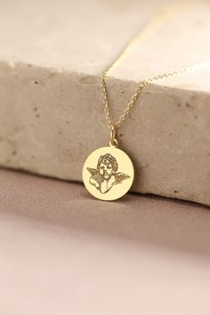 Gold Cupid Pendant -  Baby Angel Gold Necklace ● Material of pendant: Solid Gold 14k ( REAL GOLD ) ● Metal Stamp: 14k ( REAL GOLD ) ● The pendant is available in 5 sizes: - 12,7 mm / 0.5 inches (Diameter) - 14,0 mm / 0,55 inches ( Diameter ) In the photos - 15,3 mm / 0.6 inches ( Diameter ) - 16,5 mm / 0,65 inches ( Diameter ) - 19,1 mm / 0,75 inches ( Diameter ) ( In the photos the size is 14mm / 0.55 inches Diameter ) ( Jump Ring inner diameter: 4 mm ) ● Material of chain: Solid gold 14k ( REA Cute Birthstone Necklaces For Gifts, Cute Birthstone Necklaces As Gifts, Cute Birthstone Necklace For Gift, Cute Necklace For Mother's Day, Cute Round Pendant Necklace For Gift, Cute Round Necklaces For Mother's Day, Cute Mother's Day Necklace, Personalized Cute Necklaces, Cute Personalized Round Necklaces