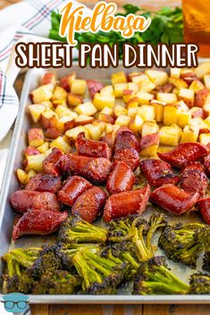 there is a sheet pan with broccoli, potatoes and other food on it