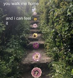 the path is lined with flowers and has an inspirational quote above it that says, you walk me home and i can feel it