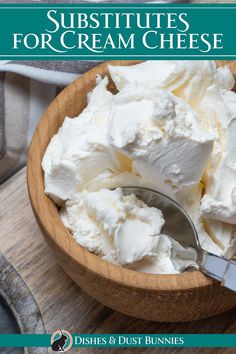 a wooden bowl filled with whipped cream on top of a table