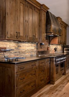 a kitchen with wooden cabinets and granite counter tops, wood flooring and an oven