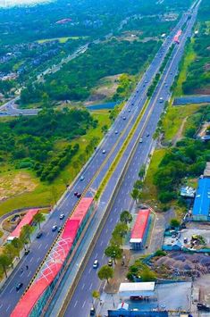 an aerial view of a highway with cars and trucks driving on the road next to it