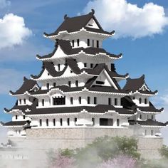 a large white and black building sitting on top of a hill