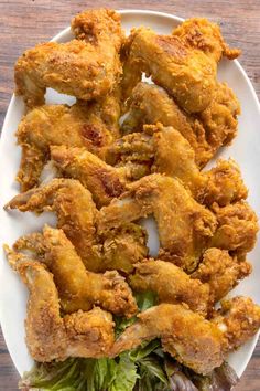 fried chicken on a white plate with lettuce