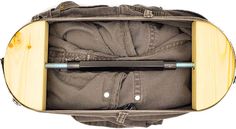 an open suitcase with clothes in it and a pen sticking out of the bottom compartment