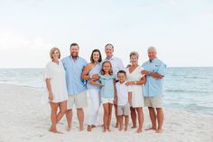 a family posing for a photo on the beach