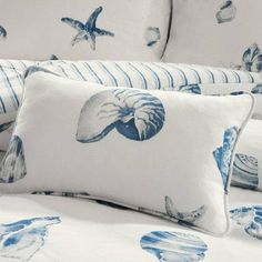 blue and white bedding with seashells on them