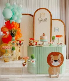 a table topped with lots of desserts and balloons