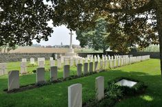 a long row of headstones sitting in the grass