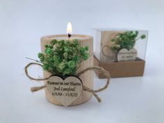 a wooden candle holder with a small plant in it and a message on the front