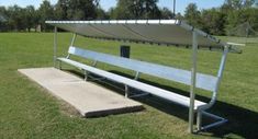 a white bench sitting on top of a lush green field