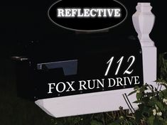 a black mailbox with white lettering on it and the words reflextive 121 fox run drive